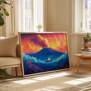 May include: A rectangular framed wall art print featuring a vibrant landscape illustration of a volcanic mountain erupting under a sunset sky with orange, yellow, and blue clouds, with a signature visible in the bottom right corner of the print.