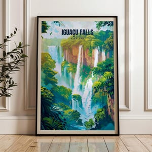 May include: A framed vertical wall art print featuring a colorful illustration of Iguacu Falls in Brazil. The artwork depicts cascading waterfalls surrounded by lush green tropical foliage, rocky cliffs, and a light blue sky with the text Iguacu Falls Brazil.