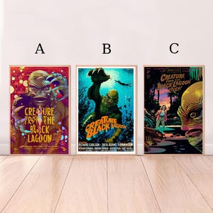 May include: Three framed movie posters featuring the Creature from the Black Lagoon. The posters have a vintage aesthetic with vibrant colours. The posters are labelled A, B, and C. The posters are displayed against a white wall.