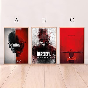 May include: Three framed posters featuring the Daredevil series. The posters have a wooden frame and feature images of the character in red and black. The text "DAREDEVIL" and "BORN AGAIN" are visible.