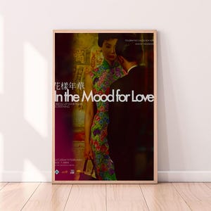 May include: A poster for the film "In the Mood for Love" featuring a couple in a romantic embrace. The poster is in a wooden frame and has a red background with the title of the film in white text. The text "Celebrating Chinese New Year, Year of the Dragon" is also on the poster.