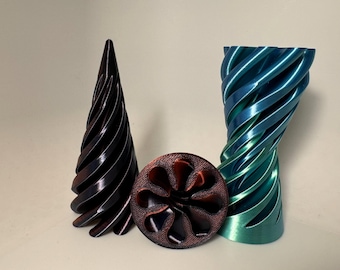 May include: Three 3D printed objects: a dark brown cone with a spiral design, a teal and blue spiral vase, and a dark brown disc with a flower-like pattern.