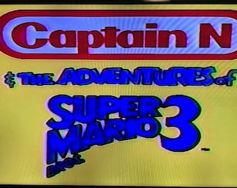 May include: A yellow background with the text "Captain N" in red and white, above "The Adventures of Super Mario 3" in blue. The image is a retro video game title screen.
