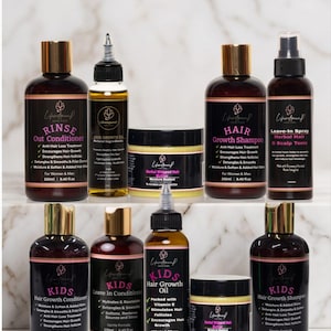 May include: A collection of ten hair care products from Lifenowned Hair Care, including bottles of shampoo, conditioner, hair growth oil, leave-in spray, and jars of herbal whipped hair butter, featuring black labels with pink text and gold caps.