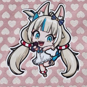 May include: A sticker featuring a cartoon anime character with long blonde hair, blue eyes, and a white dress. The character is holding a microphone and has red and white striped armbands. The background is pink with white hearts.