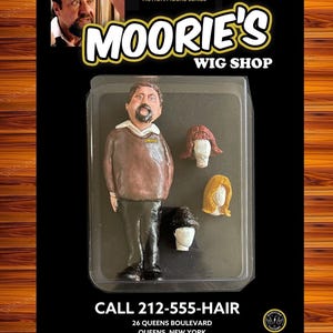 May include: A set of three ceramic mugs with a speckled, matte finish. The mugs are in shades of cream, light gray, and dark gray. Each mug has a simple, minimalist design and a rounded handle.