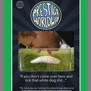 May include: A novelty card with a green border features the "Prestige Worldwide" logo. The image includes a person looking at a white object in a clear container, with text that reads "If you don't come over here and lick that white dog shit..."