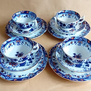 May include: Set of four vintage teacups and saucers with a blue and white floral pattern. The cups and saucers have a gold trim.