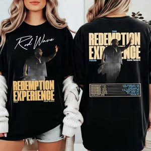 May include: Black t-shirt featuring the text "Rod Wave" in white script above a photo of a man. Below the photo is "The Redemption Experience" in yellow block letters. The back of the shirt has the same design and tour dates.