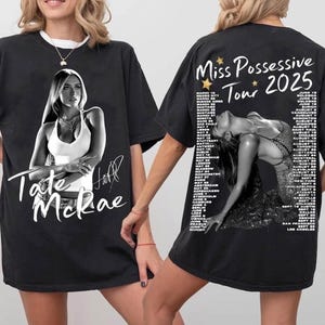 May include: Black t-shirts featuring a black and white image of Tate McRae. The front of the shirt has her name and signature. The back of the shirt has the text "Miss Possessive Tour 2025" and a list of tour dates.