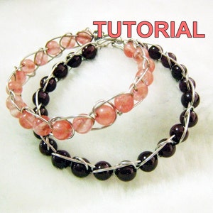 May include: Two bracelets made with wire and beads. One bracelet has pink beads and the other has dark purple beads.