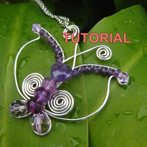 May include: A silver wire butterfly pendant with purple amethyst beads and clear crystal beads. The pendant is hanging from a silver chain and is on a green leaf background. The word "TUTORIAL" is written in pink letters on the image.