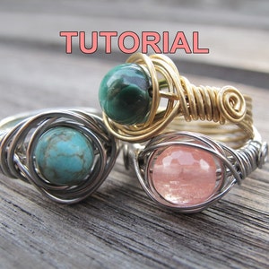 以下が含まれることがあります： 異なる色の石が付いたワイヤーで巻かれた3つのリング。リングは銀と金のワイヤーで作られています。石はターコイズ、マラカイト、ローズクォーツです。