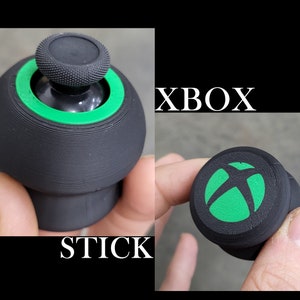 May include: Black and green Xbox controller stick replacement. The stick has a green Xbox logo on top.