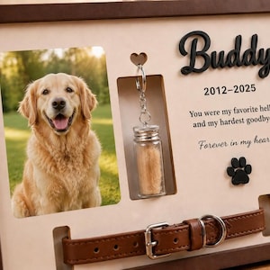 May include: A wooden memorial frame featuring a photo of a golden retriever, a glass vial on a keychain, and a brown leather collar. The text reads Buddy, 2012-2025, You were my favourite hello and my hardest goodbye. Forever in my heart, with a black paw print.