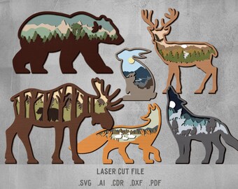 Puede incluir: Un conjunto de seis siluetas de animales de madera cortadas con láser con escenas de la naturaleza en su interior. Los animales incluyen un oso, un ciervo, un conejo, un alce, un zorro y un lobo. Las escenas de la naturaleza incluyen montañas, bosques y un cielo iluminado por la luna.