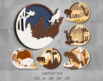 May include: Set of six laser cut wood wall decor pieces featuring woodland animals and forest scenes. The designs include a wolf howling at the moon, a deer and fawn, a bear, a bison, a bird, and a forest scene with trees and mountains.  The pieces are made of wood and have a natural finish.  LASER CUT FILE .SVG .AI .CDR .DXF .PDF