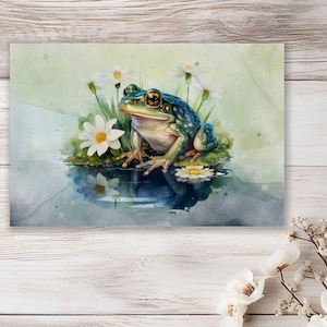 Może przedstawiać: Aquarela przedstawiająca zielono-niebieską żabę siedzącą na liściu lilii wodnej w stawie. Żaba ma duże, złote oczy i jest otoczona białymi kwiatami.