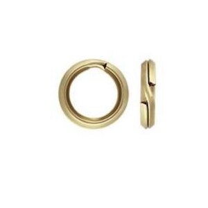 May include: Two gold-colored, round jewelry clasps. One clasp is open, showing the hollow interior, while the other is closed, displaying a side view with a unique interlocking design. The clasps are likely for necklaces or bracelets.