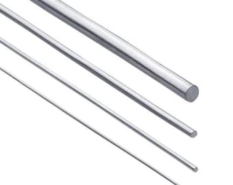 May include: Four silver metal rods of varying lengths and diameters. The rods are arranged in a staggered pattern, with the largest rod at the top and the smallest rod at the bottom.