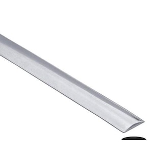 May include: A silver metal trim piece with a curved edge and a brushed finish. The trim is angled across the frame, with a black curved shape at the bottom right corner. The trim appears to be for construction or design.