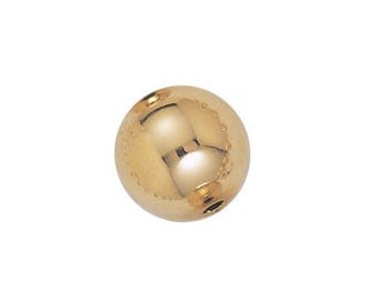 May include: A gold-colored round bead with a smooth, shiny surface.