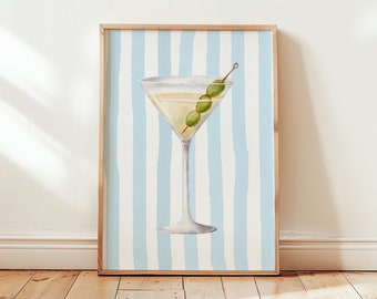 May include: A framed illustration of a martini glass with olives on a blue and white striped background.