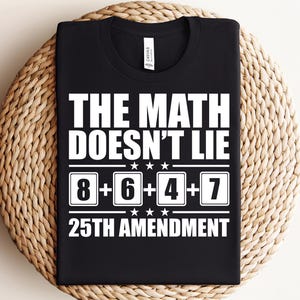 May include: Black t-shirt with white text that reads "THE MATH DOESN'T LIE" above the equation "8+6+4+7" and "25TH AMENDMENT". The shirt is displayed on a woven, circular placemat.