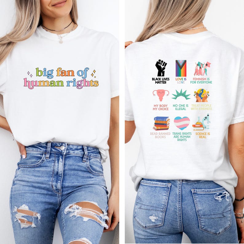 May include: White t-shirt with the text "big fan of human rights" in colorful lettering on the front. The back of the shirt features various graphics and phrases, including "Black Lives Matter" and "Feminism is for Everyone".