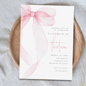 May include: Pink watercolour bow with a white background. The text "please join us to celebrate ELIZABETH IS thirteen" is printed on the invitation. The date and time of the event are listed as "MARCH 14 | 3PM". The address is "1236 BOW ST COQUETTE AVE BROOKLYN, NY 54123". The RSVP information is "RSVP TO AVERY 123.456.9876".