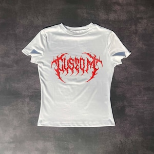 May include: White t-shirt with a red "CUSTOM" graphic in a metal font.