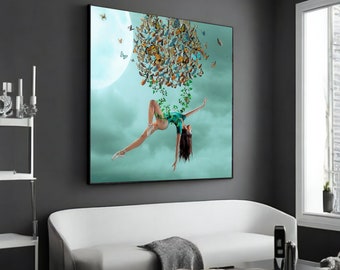 May include: A woman in a green leotard is suspended in the air, surrounded by a cluster of colorful butterflies. The background is a light blue sky with a white moon.