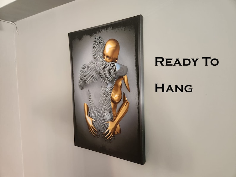 May include: A 3D wall art piece featuring two figures embracing. The figures are made of metal and painted in gold and silver. The artwork is ready to hang.