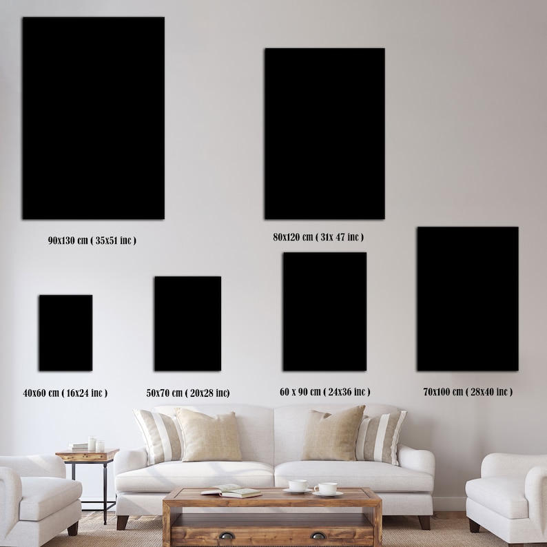 May include: A comparison of different sizes of black framed artwork displayed on a white wall above a white couch and a wooden coffee table. The measurements of each frame are listed below each frame.