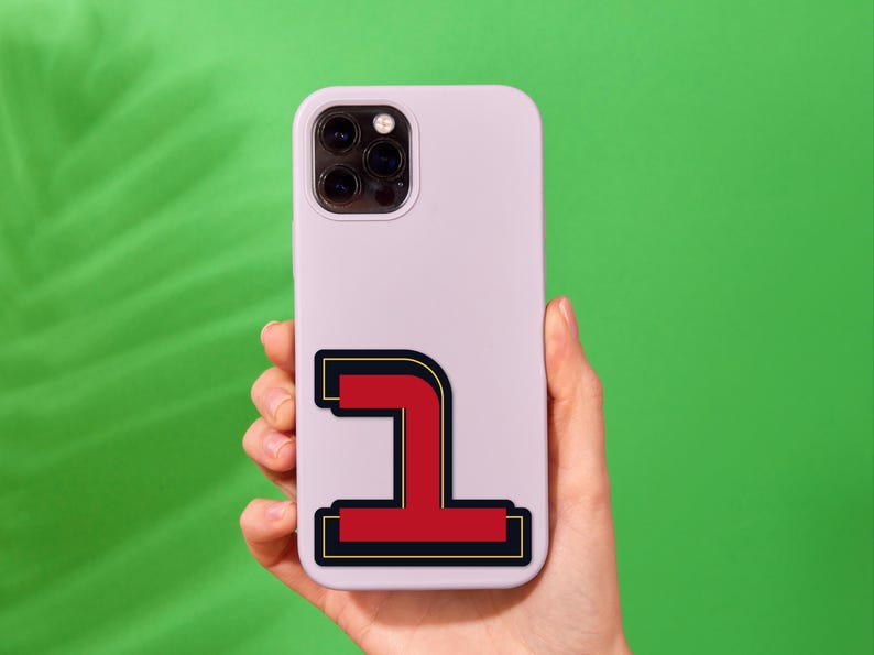 May include: A white phone case with a red and black sticker of the number one on it.