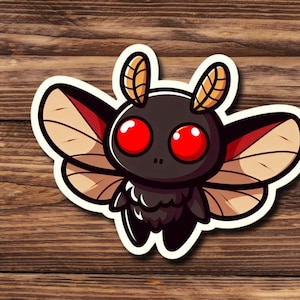 May include: A cartoon illustration of a black moth with red eyes and brown wings. The moth is drawn in a cute, stylized way and has a white outline.
