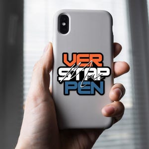 May include: A white phone case with a sticker that says "VER STAP PEN" in orange, white, and blue lettering.
