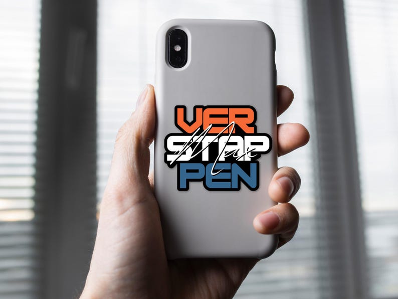 May include: A white phone case with a sticker that says "VER STAP PEN" in orange, white, and blue lettering.