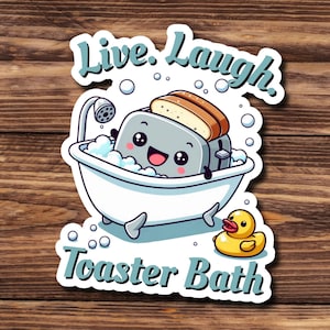 May include: A white bathtub with a cartoon toaster inside, surrounded by bubbles. The toaster has a smiling face and is holding a slice of bread. The text "Live. Laugh. Toaster Bath" is written below the bathtub.