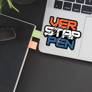 May include: A laptop computer with a sticker that says "VER STAR PEN" in a bold, colorful font. The sticker is on the top right corner of the laptop, above the trackpad.