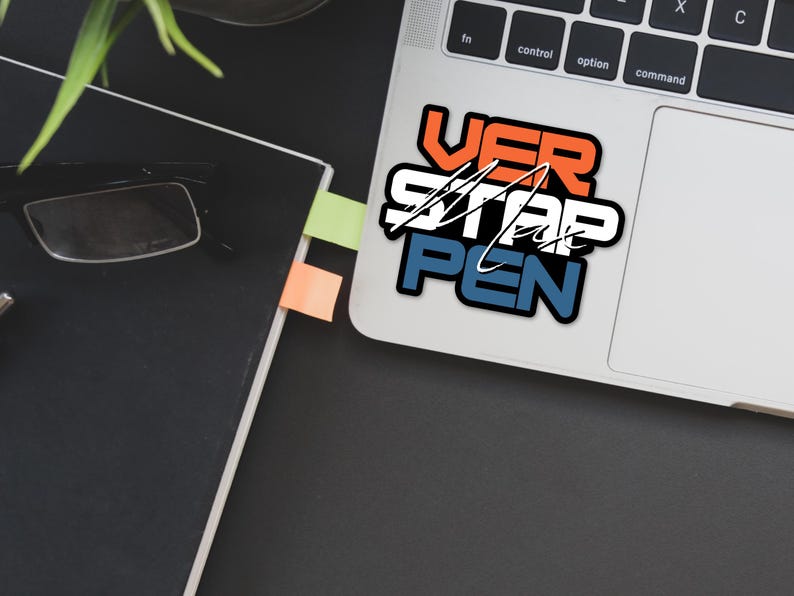 May include: A laptop computer with a sticker that says "VER STAR PEN" in a bold, colorful font. The sticker is on the top right corner of the laptop, above the trackpad.