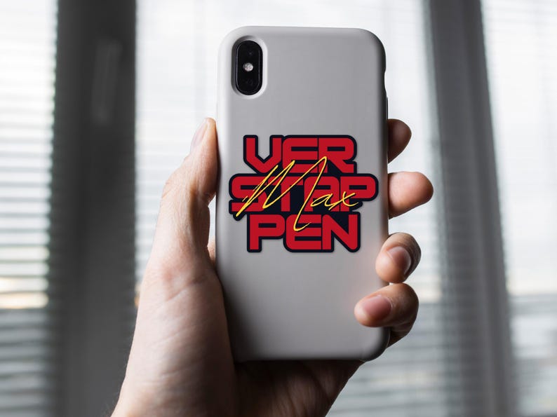 May include: A white phone case with a red and black sticker that says "VER STAP PEN" with the name "Max" written in gold lettering.