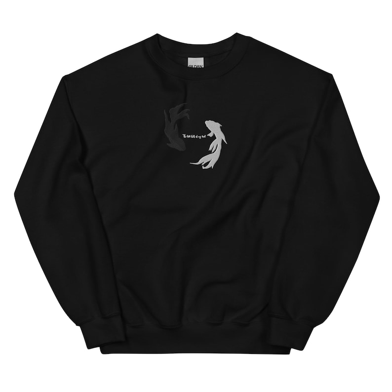 May include: Black sweatshirt with a yin yang design featuring two fish, one black and one white, with the word "Equilibrium" written in white.