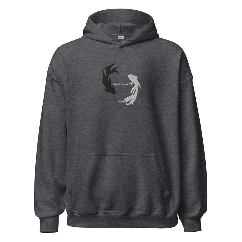 May include: A dark heather grey hoodie with a black and white fish design and the text "The world is my sea".