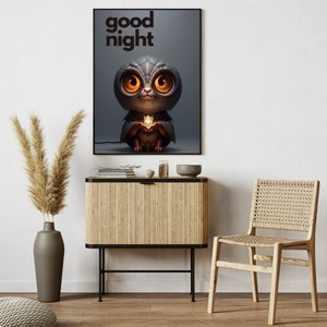 May include: A framed print with a black background and the text "good night" in white. The print features a cartoon illustration of a gray owl with large, yellow eyes holding a glowing orb.