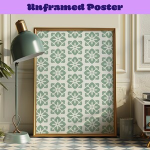 May include: A framed poster with a repeating floral pattern in shades of green and white. The frame is gold. The text "Unframed Poster" is at the top of the image in purple. The poster is displayed in a room with a green lamp and a patterned floor.