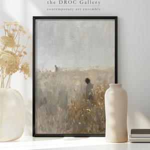 May include: A framed painting of a landscape with a single figure standing in a field of tall grass. The sky is a muted gray and the grass is a mix of brown and green. The painting is in a black frame and is hanging on a white wall.