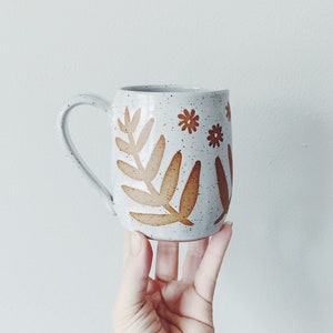 White Garden Ceramic Mug, white coffee cup with leaf and flower designs, speckled white pottery wheel thrown white mug