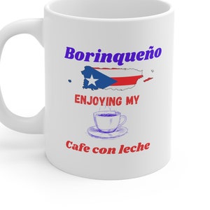 May include: White ceramic mug with a blue and red Puerto Rican flag design and the text "Borinqueño Enjoying My Cafe con Leche".