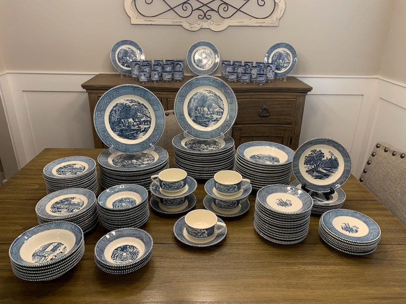 May include: A collection of blue and white china dinnerware with a floral pattern. The set includes plates, bowls, cups, and saucers.